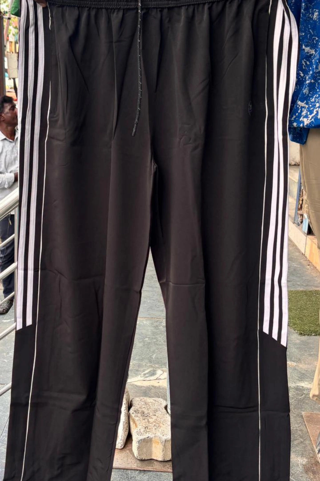 ShopTheBrandSpot plus size black baggy terry track pants for men made from breathable premium terry fabric, featuring white side stripes, adjustable drawstring waistband, and relaxed oversized fit ideal for casual, travel, and everyday wear.