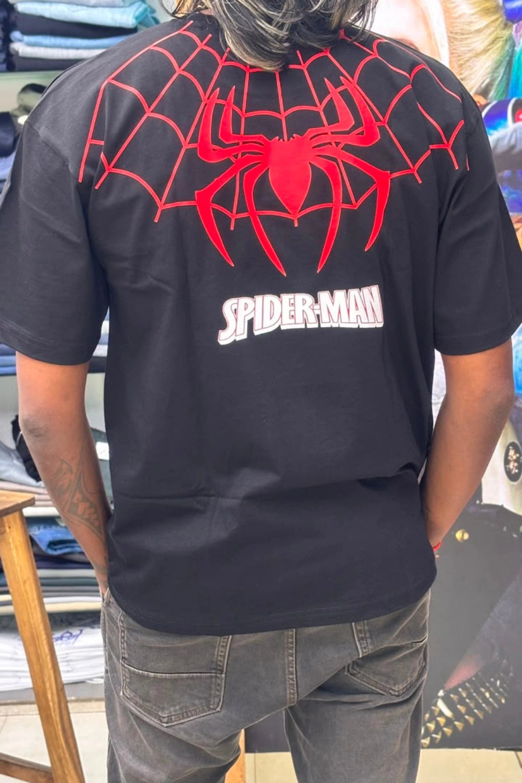 Back view of Black Spiderman printed oversized t-shirt for men, featuring large red spider web graphic and white Spiderman logo on the upper back, plus sizes 3XL