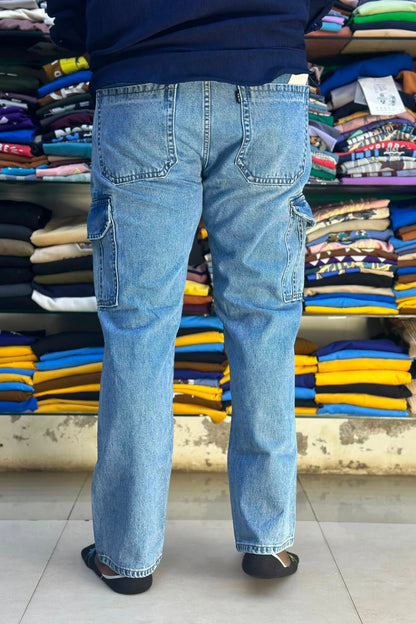 Back view of men's mid blue 6 pocket cargo jeans showing functional back pockets and side cargo flaps in sizes 38 and 40 by TheBrandSpot