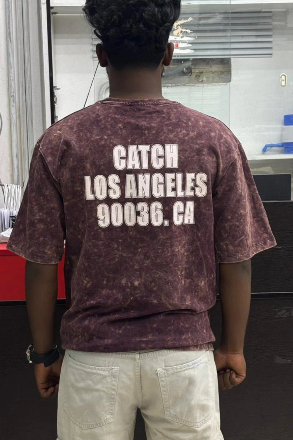 Back view of men's wood bark oversized cotton t-shirt with CATCH LOS ANGELES print in sizes M to XL by TheBrandSpot