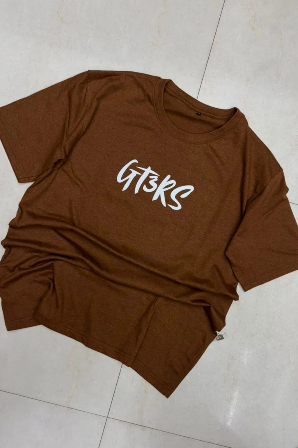Front view of men's mahogany brown plus size t-shirt featuring GT3RS chest text print in sizes 3XL to 6XL by TheBrandSpot