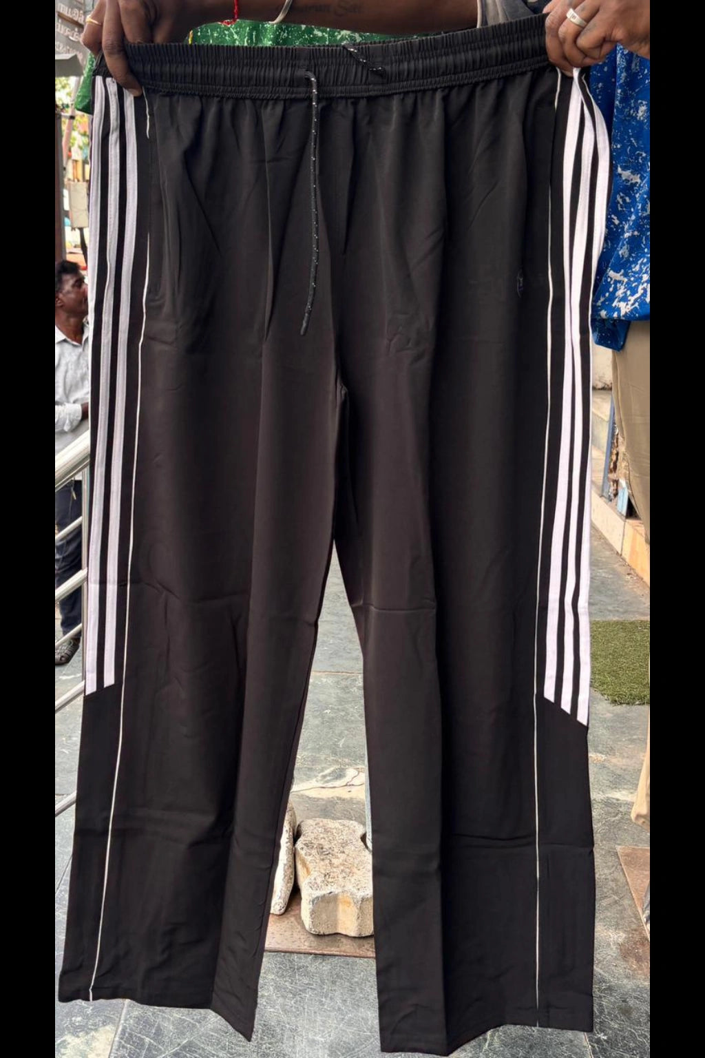 Men's black plus size baggy terry track pants with side stripes and elastic waistband in sizes 3XL to 7XL by TheBrandSpot
