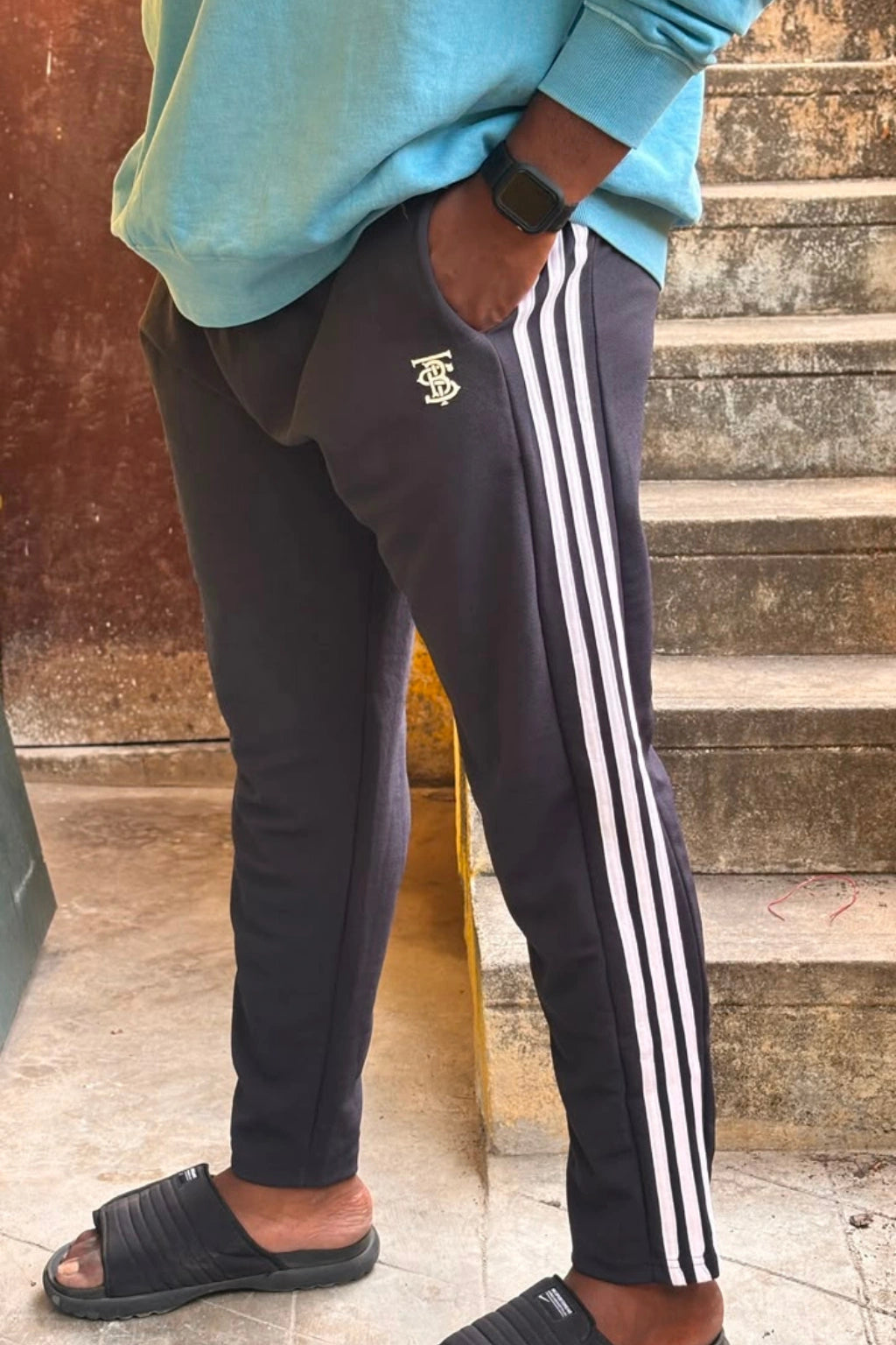 Men's dark charcoal striped plus size track pants with white side stripes and elastic waistband in sizes 2XL to 7XL by TheBrandSpot