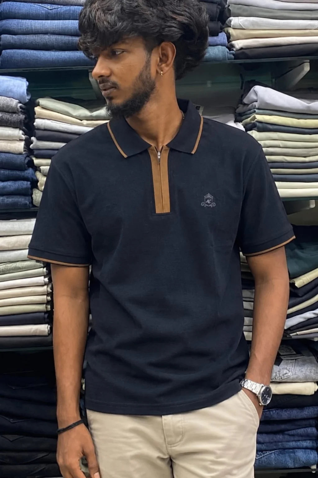 Men's zip collar polo t-shirt in Monarch Navy color variant paired with beige pants by The Brand Spot