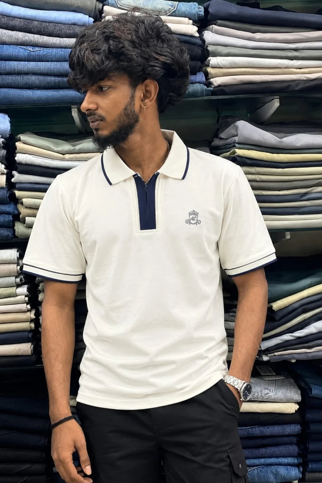 Men's zip collar polo t-shirt in Sweet Cream color variant paired with black pants by The Brand Spot